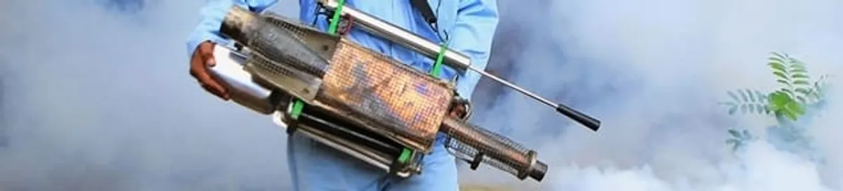 Fumigation technician using a fogger for deep pest treatment in Grand Rapids, MI